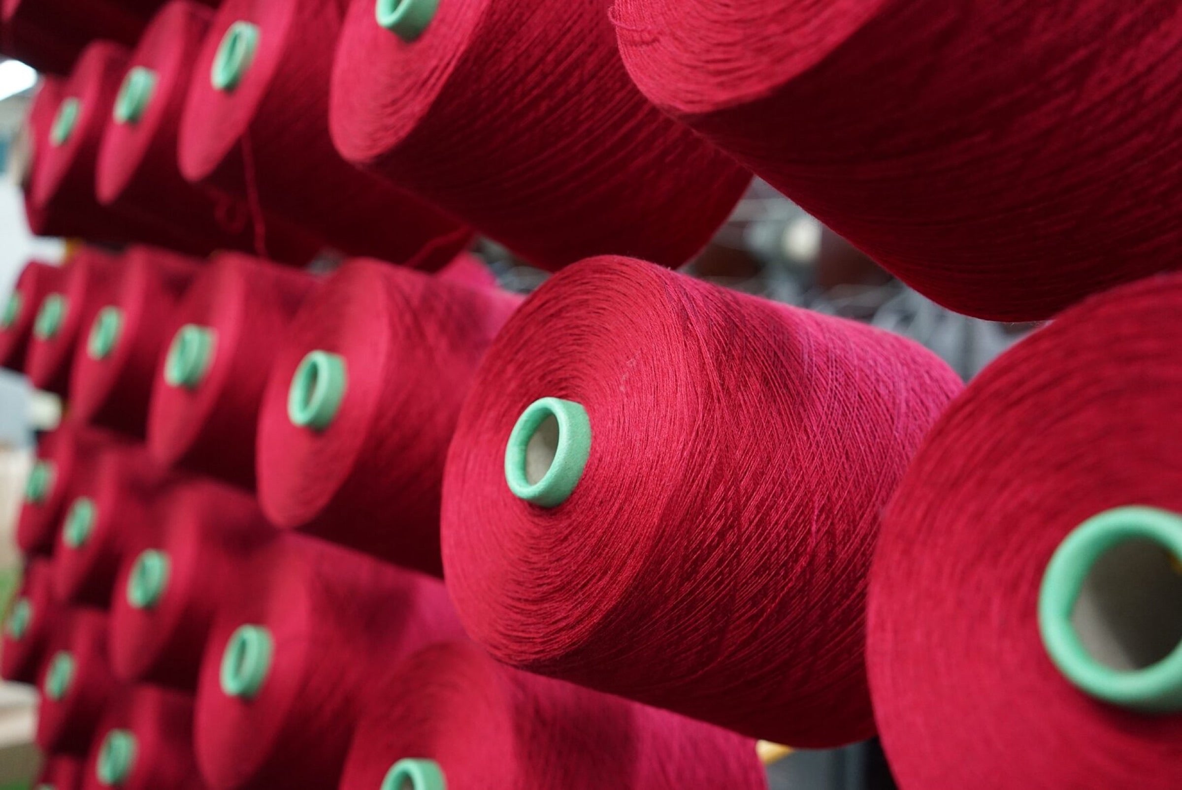Dyed merino yarn on cones in the mill