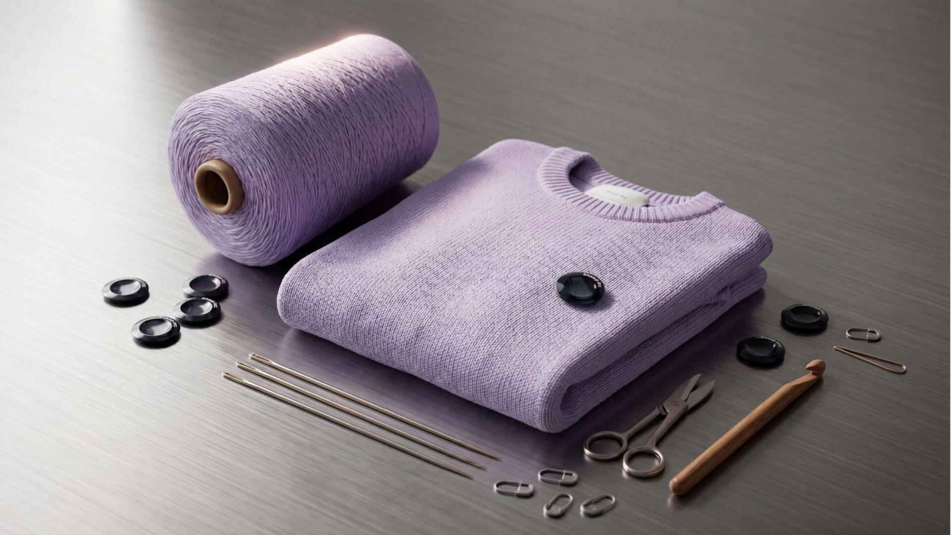 Folded lavender knit with yarn cone, NFC dots and repair tools