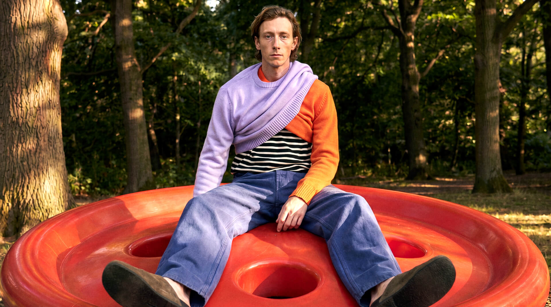 Model wearing Sheep Inc. knitwear in a sunlit landscape
